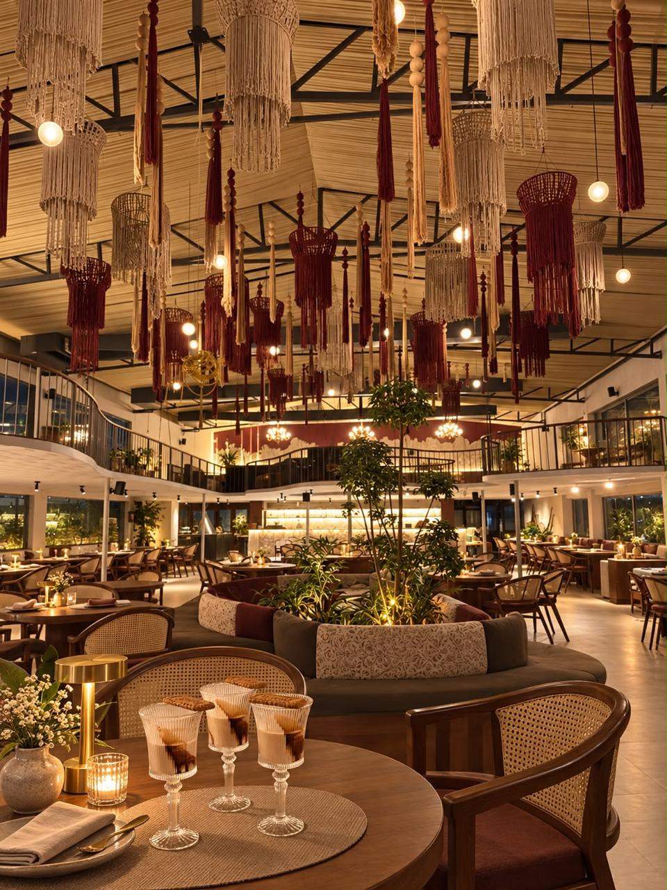 Countryside Meadows dining hall with macrame lanterns, cane chairs and plants